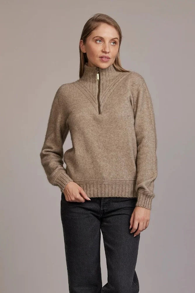 Possum and Merino  5040 Ridge Funnel Neck – A beautiful sweater made from the ultimate combination of natural fibres for warmth without weight.  Featuring ridge patter neck detailing and ¼ zip for ease of wear.  ¼ zip and high collar Feature rib knit on neck Mid-weight warmth 35% Possum Fur, 55% Merino Wool, 10% Pure Mulberry Silk New Zealand designed and manufactured