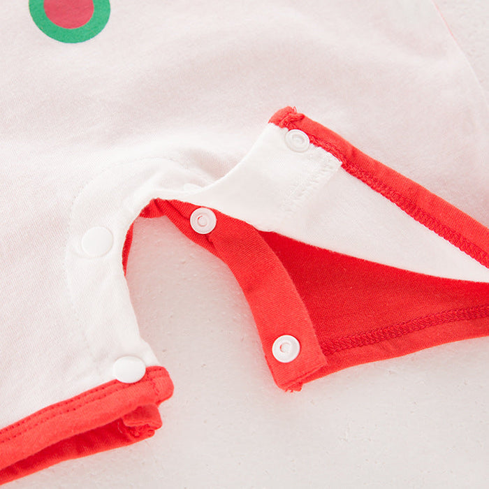 Detail of baby clothing for New Year and Christmas featuring red accents and snap closures.