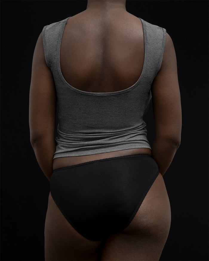 Back view of a model wearing Kye Recline bateau sleeveless in heathered charcoal. The breathable bamboo fabric provides comfort and style, perfect for everyday wear by Kye Intimates.