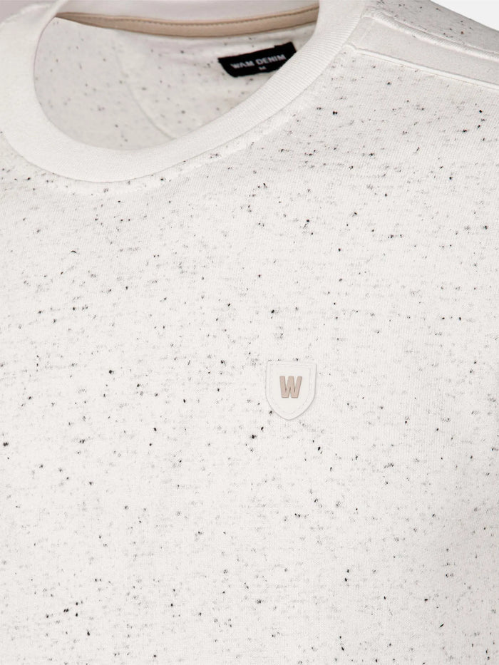 White speckled sweater with a logo on a white background