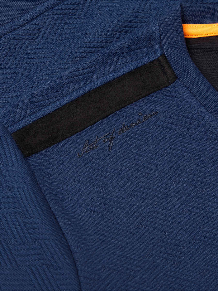 Close-up of navy Moorland Sweater with logo patch. – Wam Denim.