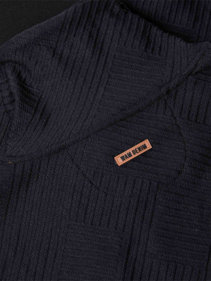 Close-up of chest logo and drawstring detail on black textured sweater – Wam Denim.