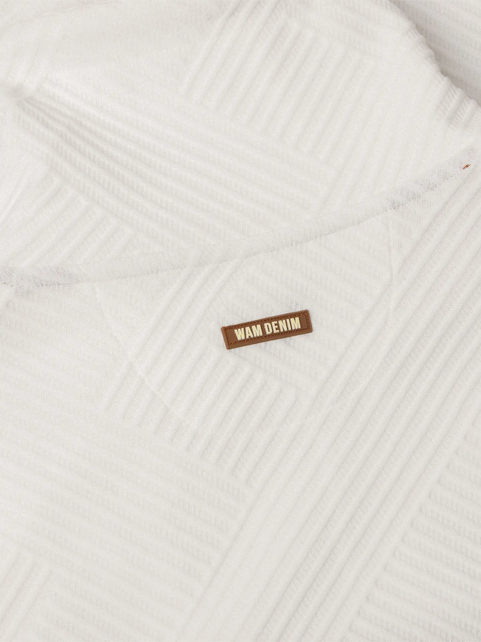 Close-up of white textured sweatshirt fabric with stitched Wam Denim logo patch – Wam Denim.