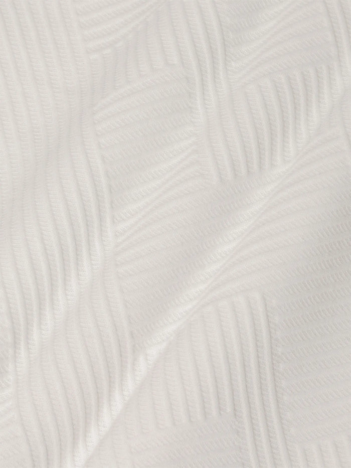 Close-up of white sweatshirt fabric featuring soft geometric textured pattern – Wam Denim.
