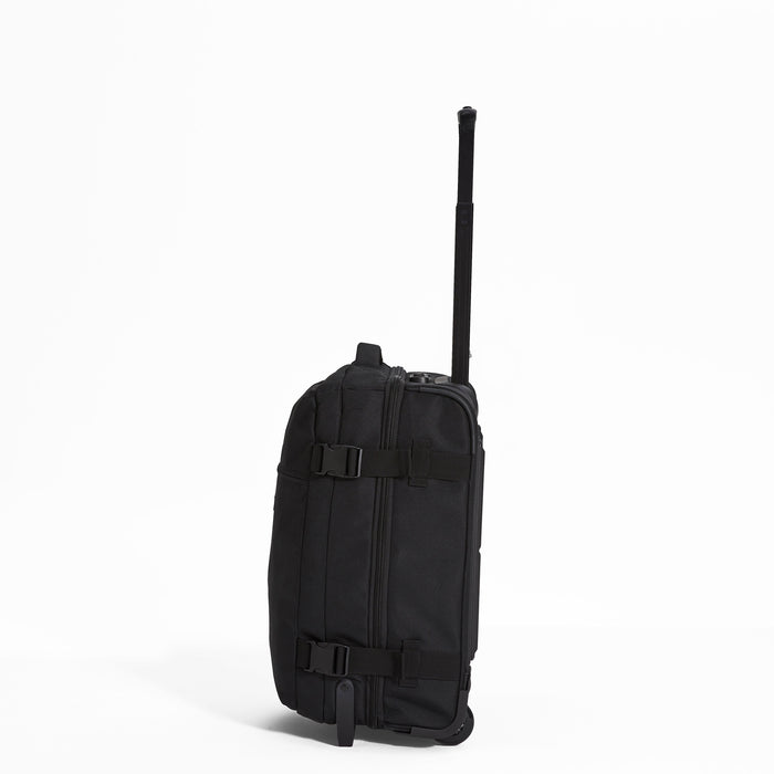 Ela Mo™ Reisetasche mit Rollen 42 Liter | Black. Reisetasche mit Klickverschluss von der linken Seite auf weißem Hintergrund