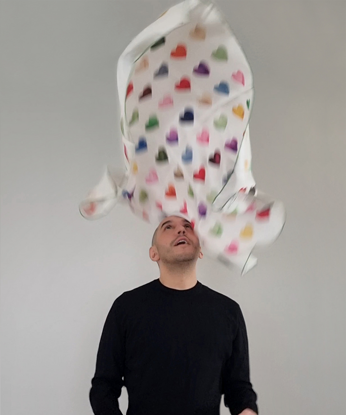 Man throwing Nuno Da Costa scarf in air