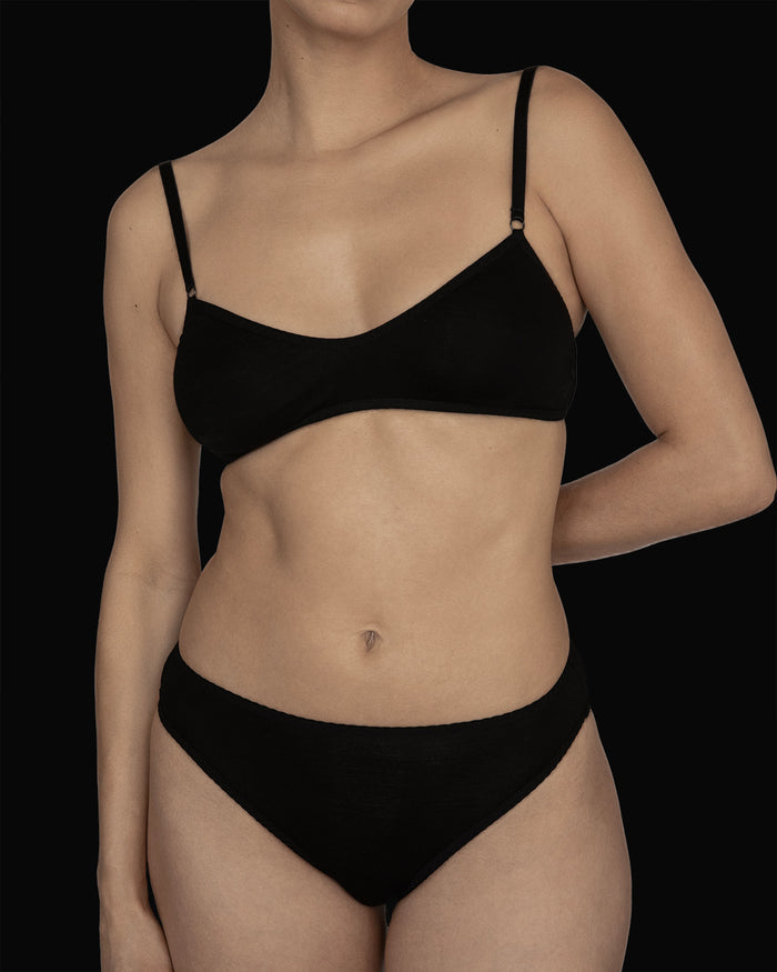 Model wearing Kye Recline Brief bamboo French cut briefs in black. The high-cut design and soft bamboo fabric offer a comfortable and stylish fit, perfect for everyday wear by Kye Intimates.