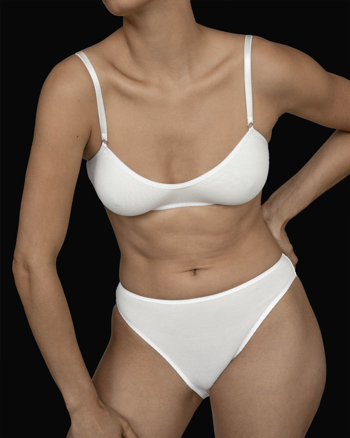Close up view of a model wearing Kye Recline Brief bamboo French cut briefs in white. The breathable bamboo fabric and modern design highlight the comfort and style provided by Kye Intimates.