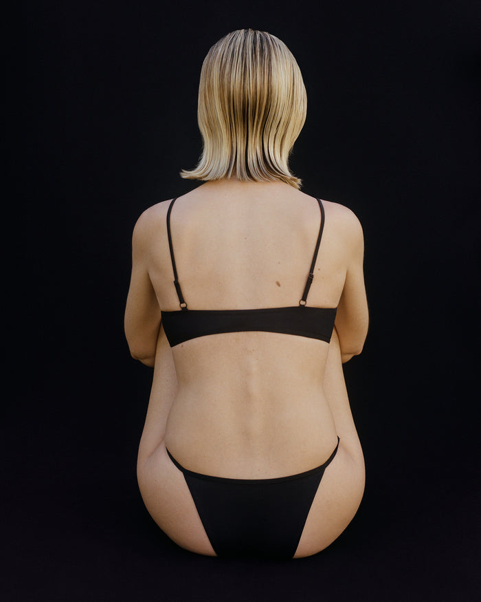 Back View of String Swim Bottom in Black from KYE Intimates in Los Angeles.
